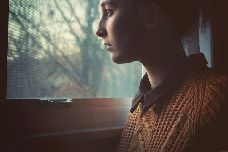 Young woman looking out a window