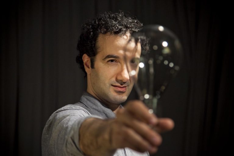 Jad Abumrad holding a light bulb