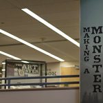 Photo of the inside of a office building with a banner that reads Making a monster