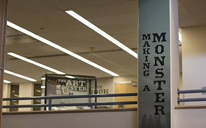 Photo of the inside of a office building with a banner that reads Making a monster