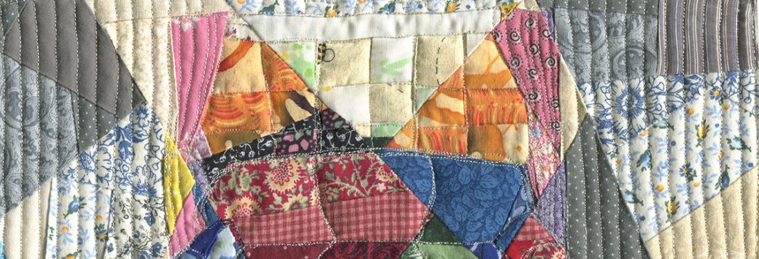 A couch in front of a window, but it is pieced from multiple fabrics and quilted. It is fragmented and multicolored.